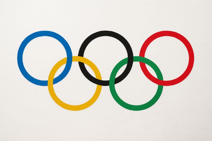 AI generated image of The Olympic Rings symbol, introduced in 1913 by Pierre de Coubertin, representing the unity of five continents with blue, yellow, black, green, and red rings on a white background