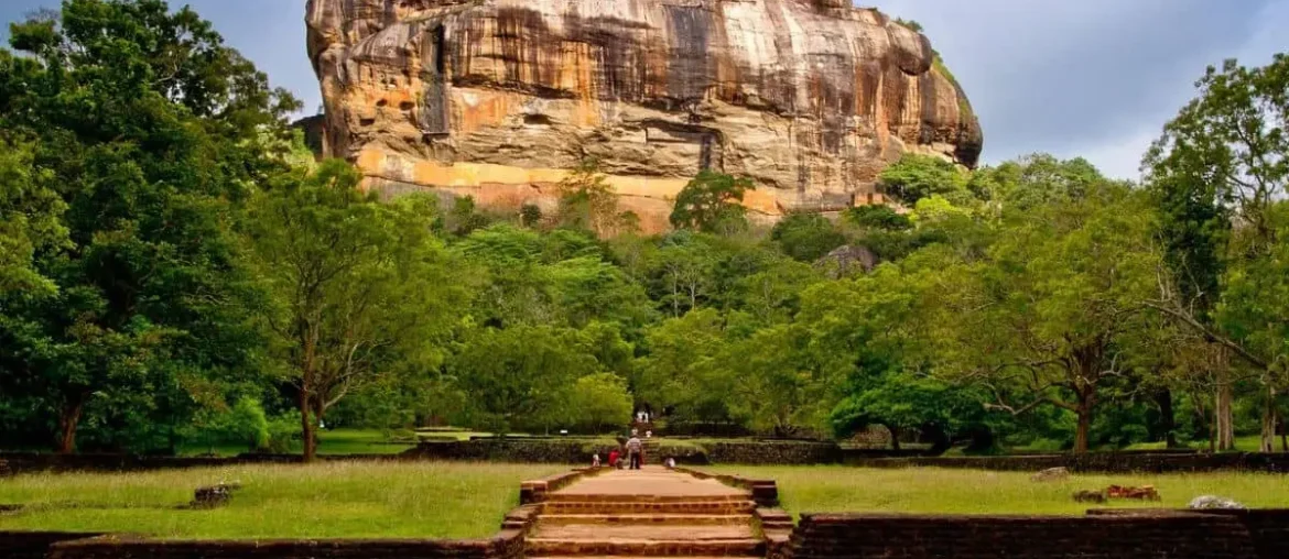 Front view of Sigiriya Rock Fortress surrounded by green gardens in Sri Lanka