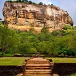 Front view of Sigiriya Rock Fortress surrounded by green gardens in Sri Lanka