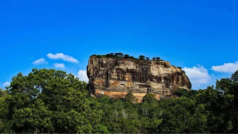 Front view of Sigiriya Rock Fortress surrounded by green gardens in Sri Lanka