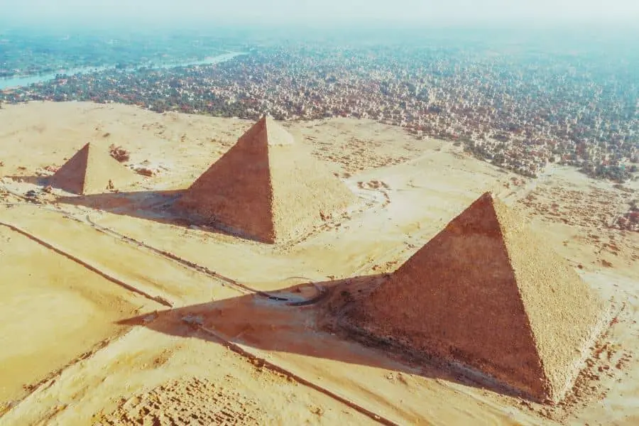 aerial view pyramids of Egypt secrets Giza plateau desert landscape wide shot 